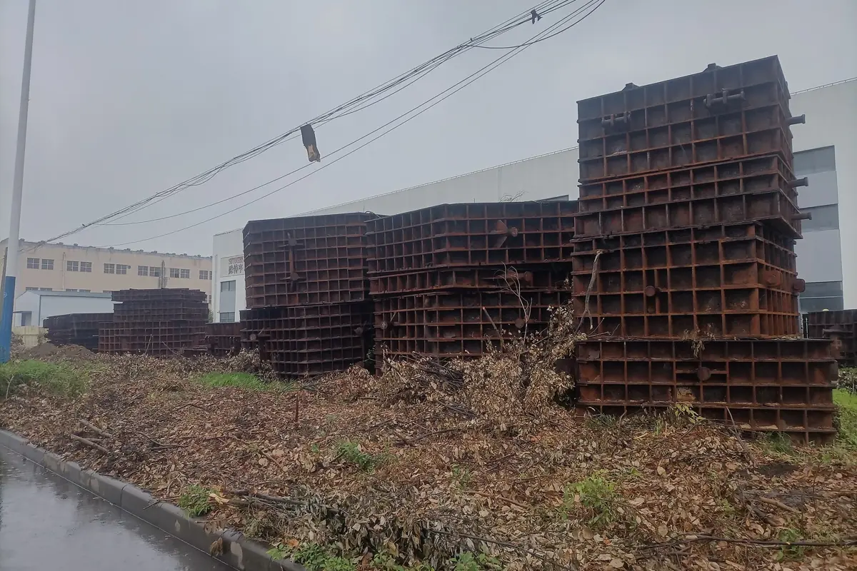 Stacks of steel channels piled up beside a road
